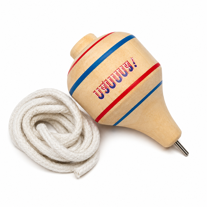Trompo dieciochero tricolor junto a una lienza enrollada, juego típico chileno de Fiestas Patrias