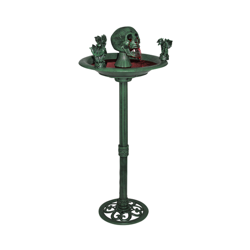 Fuente decorativa de Halloween con pedestal verde, calavera y gárgolas sobre la taza