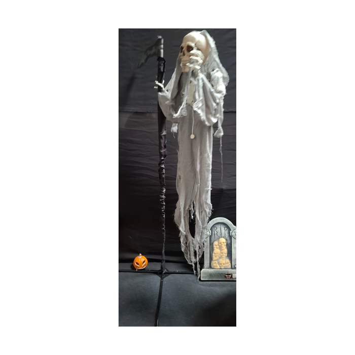 Espectro flotante esqueleto con túnica de gasa gris y guadaña sobre pedestal, foto real en tienda